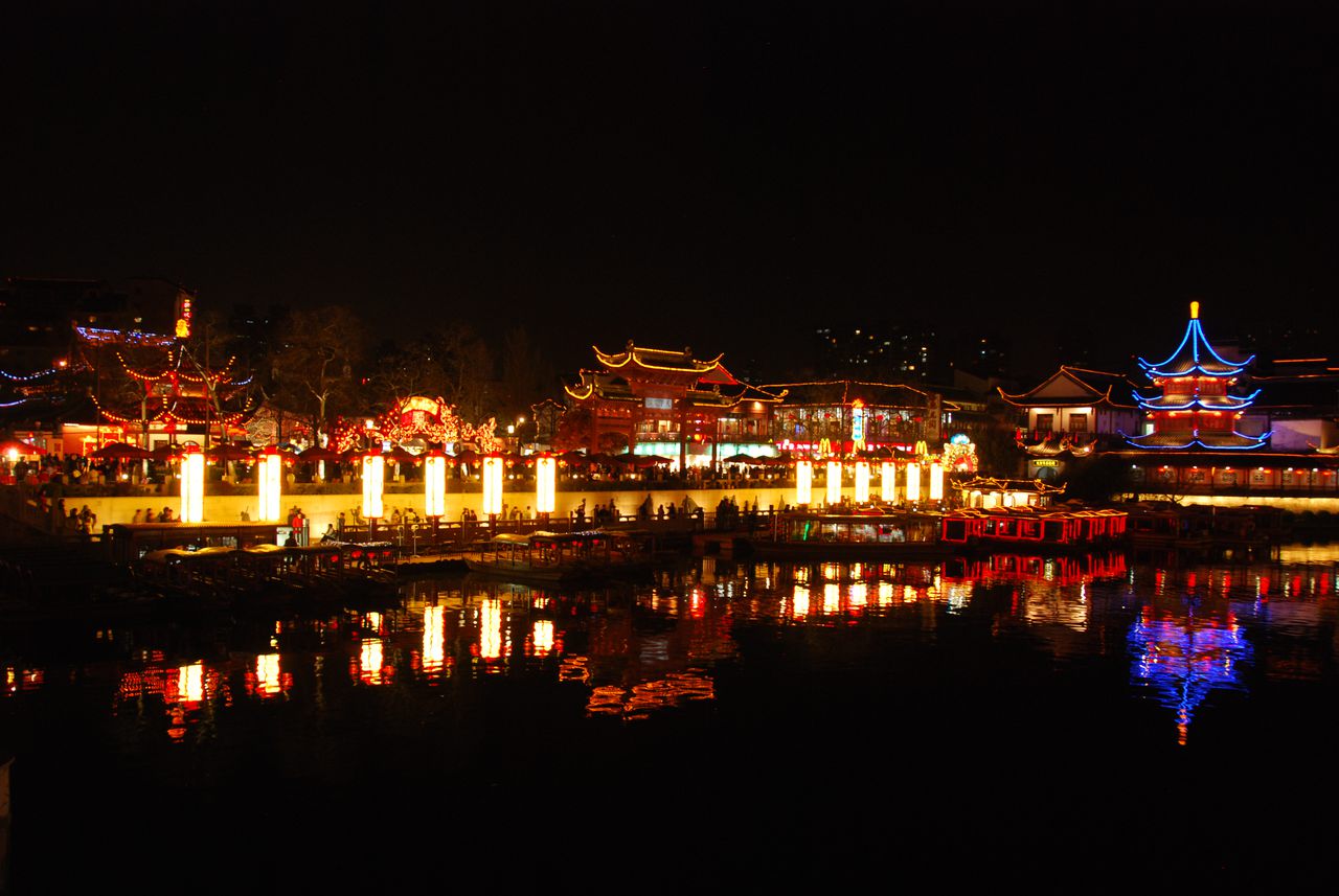 Lantern-lit halls of the Confucius Temple reflected in the Qinhuai River at night