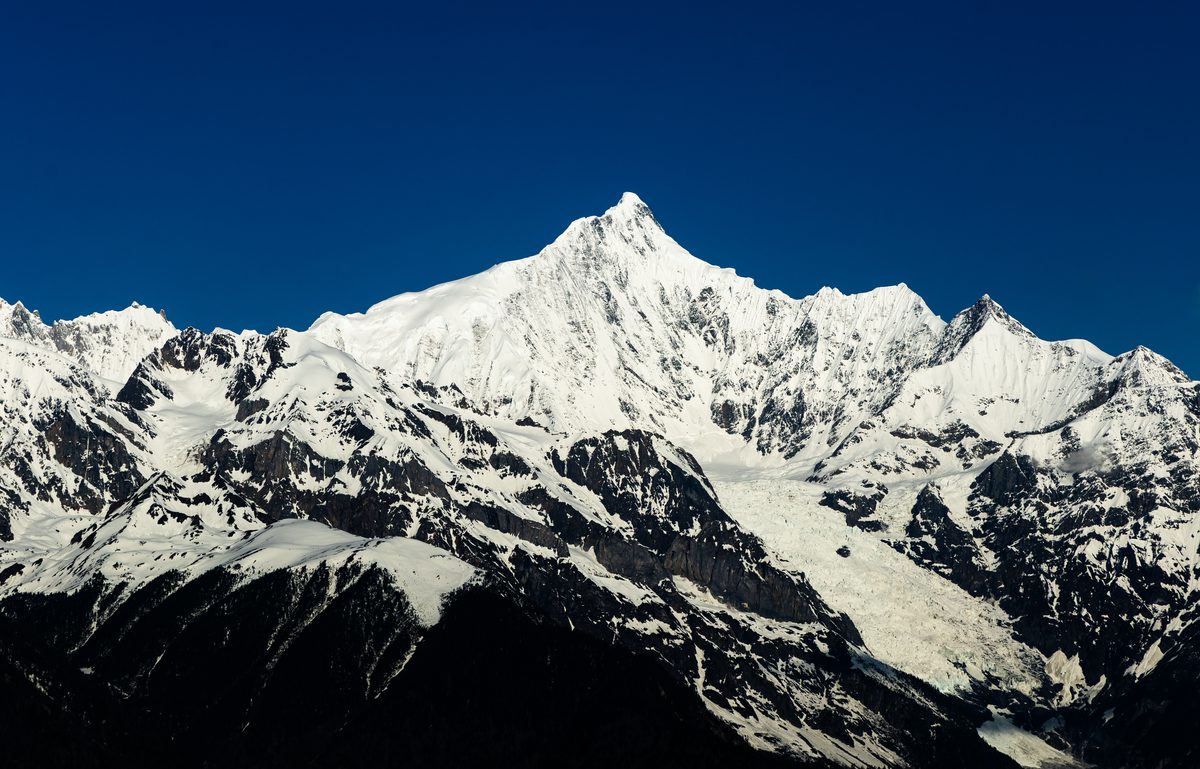 The snow-capped peaks of Meili Snow Mountain against a clear sky